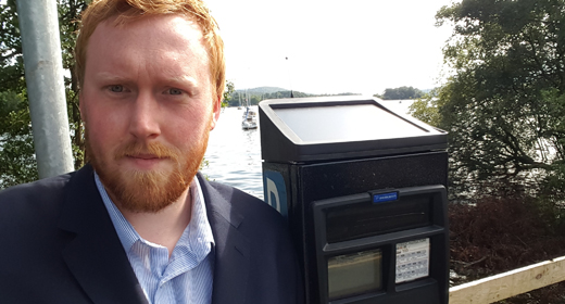 Windermere councillor Ben Berry next to Windermere Ferry’s shore-based ticketing machine.
